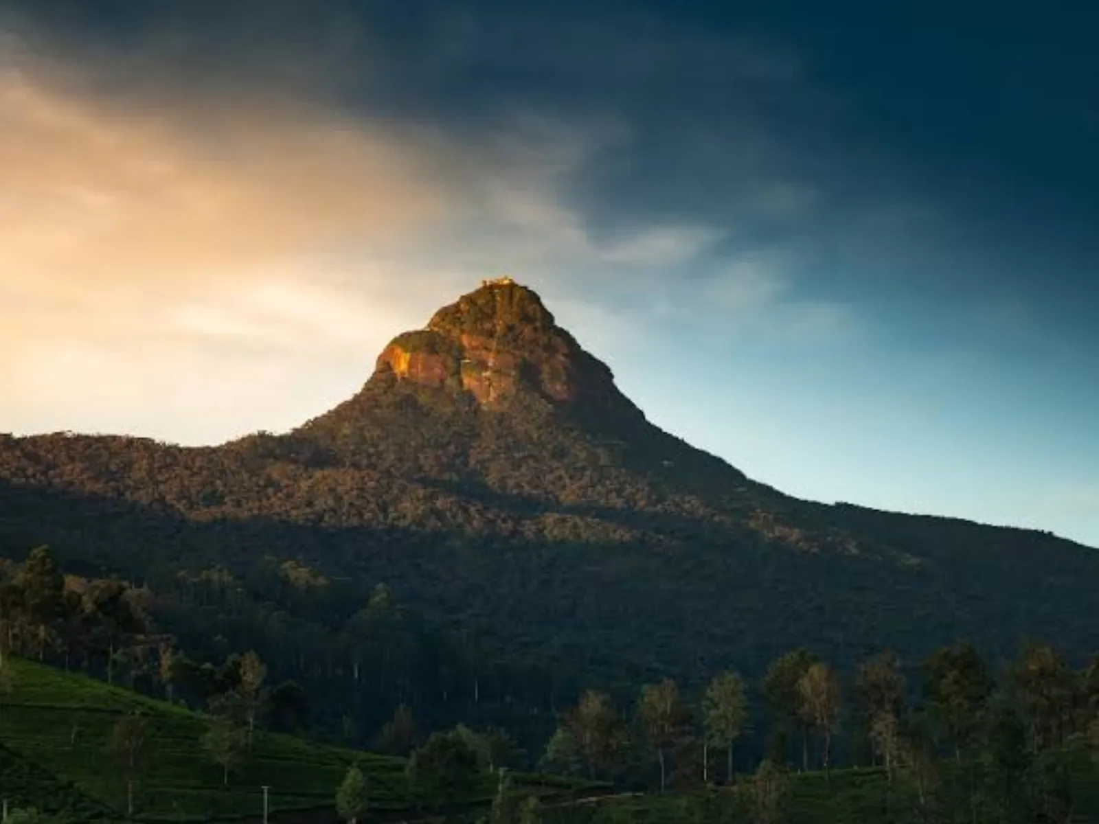 The silhouette of Adam's Peak at dusk in Sri Lanka's hill country